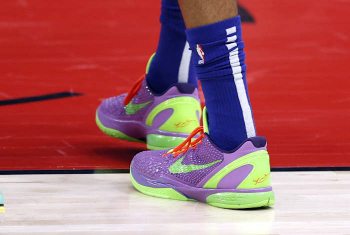 Philadelphia 76ers forward Tobias Harris' purple and green Nike Kobe sneakers.